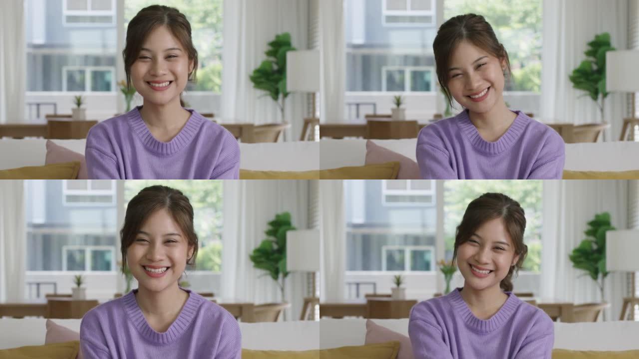 肖像迷人的亚洲女性影响者视频博客对着镜头微笑。