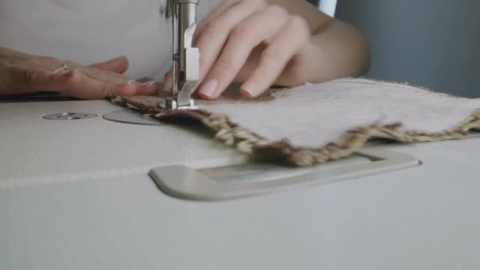 女人在缝纫机上缝制衣服