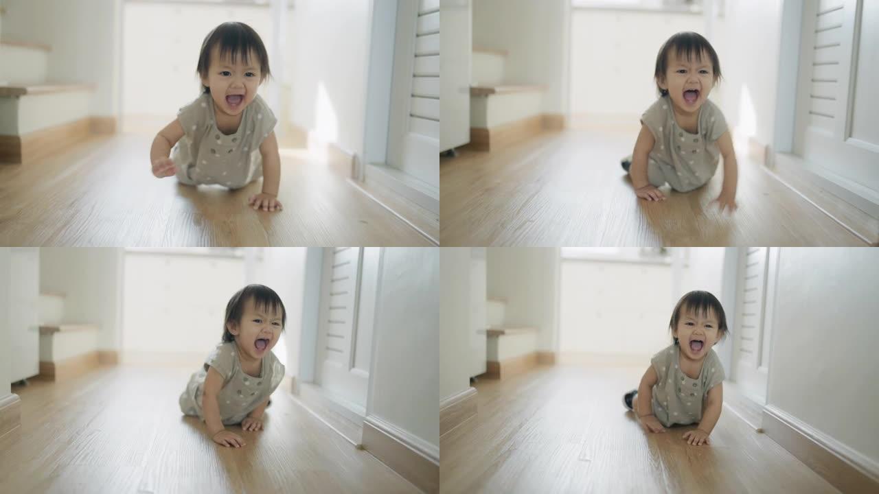 小女孩在她的房子里快乐地练习走路和爬行。