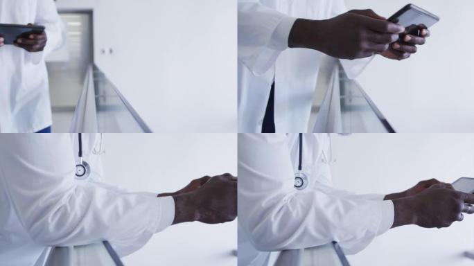非裔美国男性医生口罩的中段使用平板电脑在医院走廊行走
