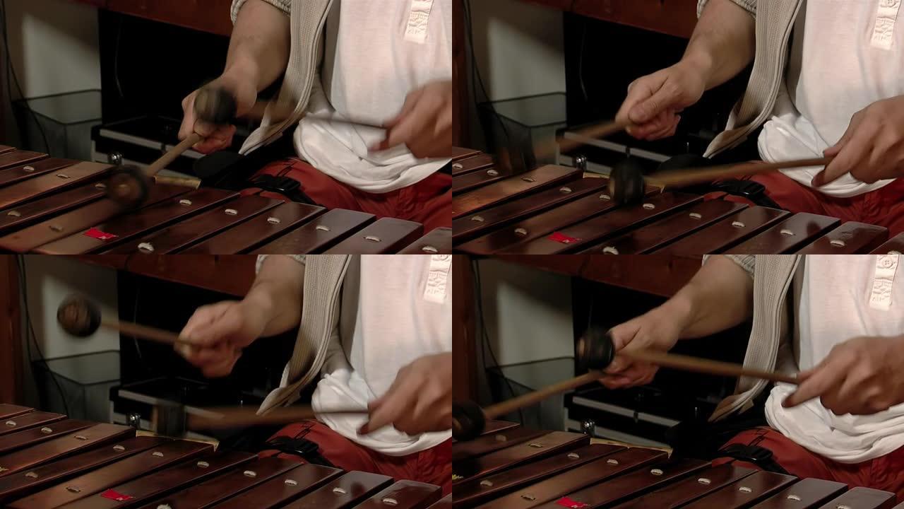 木琴演奏者，演奏木琴的男音乐家，木琴的木棒被木槌击中。特写。