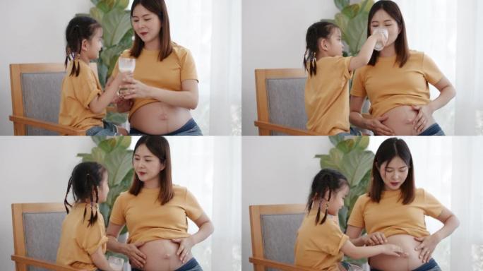 怀孕的母女为姐姐喝牛奶