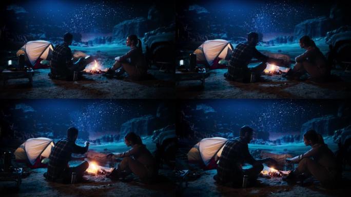 幸福的夫妇晚上一起在峡谷荒野露营，坐在篝火旁，用地图计划徒步旅行。两个旅行徒步旅行者交谈，银河之星观