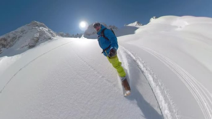 年轻的男性滑雪者喜欢沿着刚被雪覆盖的山坡骑行