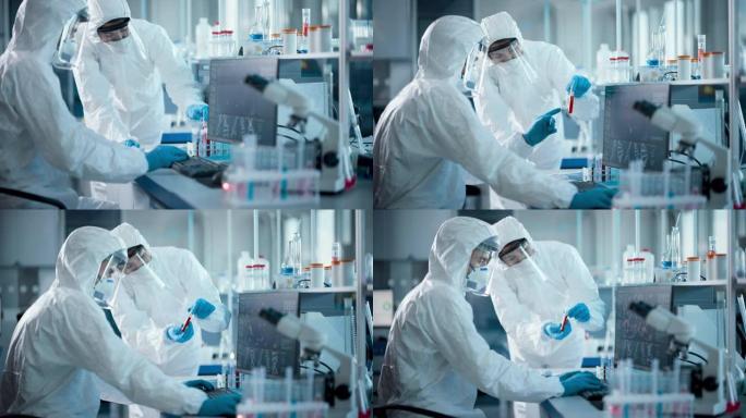 医学实验室: 微生物科学家团队穿着无菌工作服，面罩和口罩交谈，使用计算机分析血液样本并开发疫苗，药物