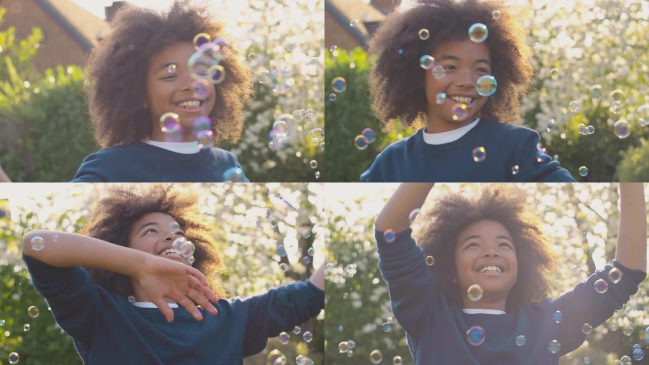 微笑的男孩在户外玩花园里的泡泡很开心 -- 慢动作拍摄