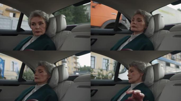 一位中年女商人在艰难的谈判前冷静地坐在车里，集中注意力
