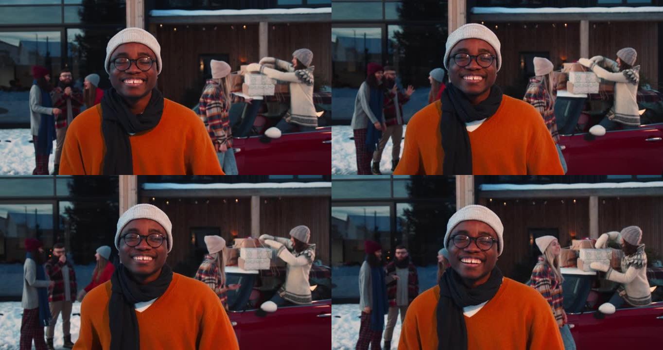 年轻快乐兴奋的非洲裔美国男子穿着冬装在有趣的圣诞朋友派对慢动作中对着镜头微笑。