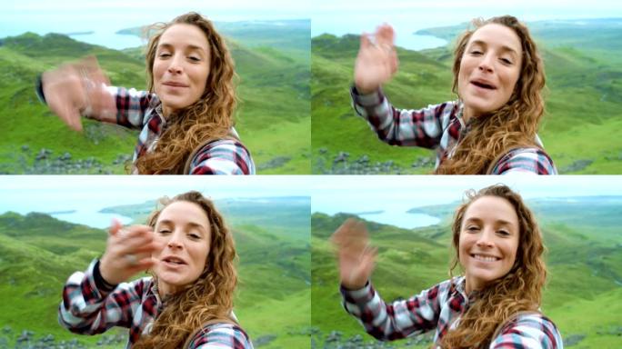 4k视频片段，一位迷人的年轻女子在山谷徒步旅行时录制了一段视频