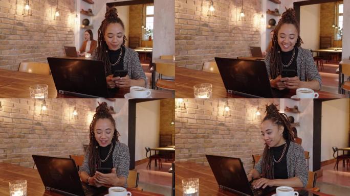 美丽的女人坐在咖啡店里，在笔记本电脑上工作