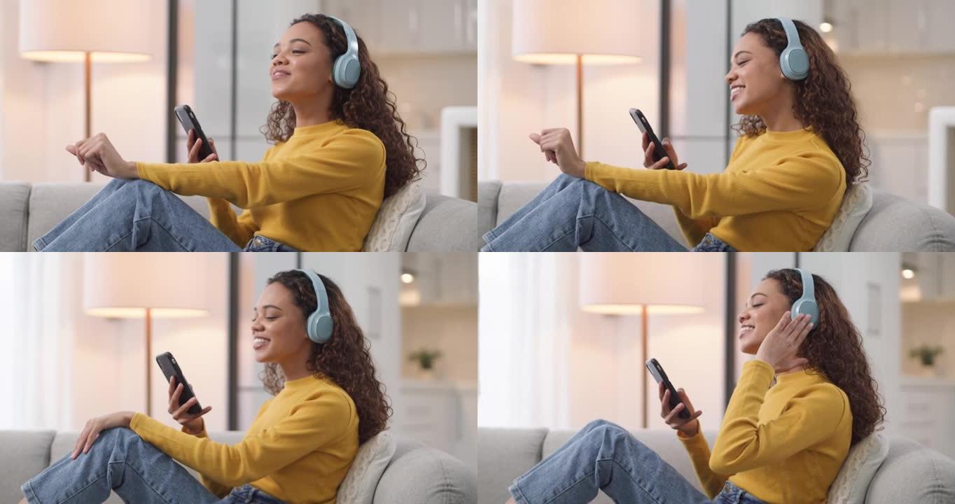 一名年轻女子在家中沙发上使用智能手机和耳机的4k视频片段