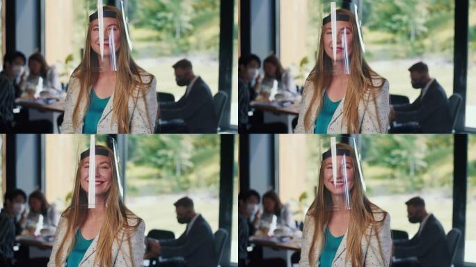 年轻快乐的白人商务妇女肖像戴着透明的面罩保护在工作场所的慢动作。