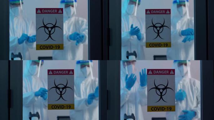 两名男性科学家在实验室技术研究中穿着防护服，对冠状病毒病毒或Covid-19.Health护理研究人