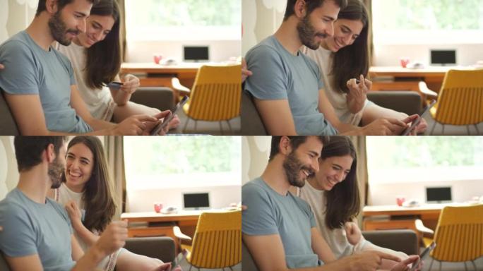 一对年轻夫妇使用数字平板电脑进行在线支付的4k视频片段
