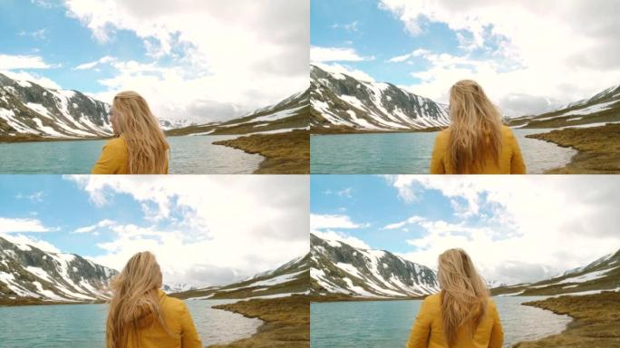 4k视频片段，一名年轻女子在m ø re og Romsdal欣赏湖景