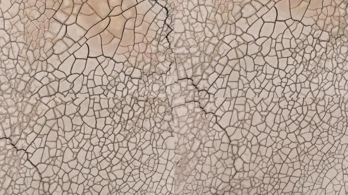 由于气候变化和全球变暖造成的干旱，干旱大坝的图案化开裂的泥浆表面的鸟瞰图