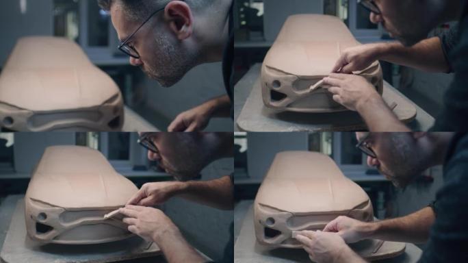 汽车设计师使用整形工具制作原型车，以创建流畅的细节