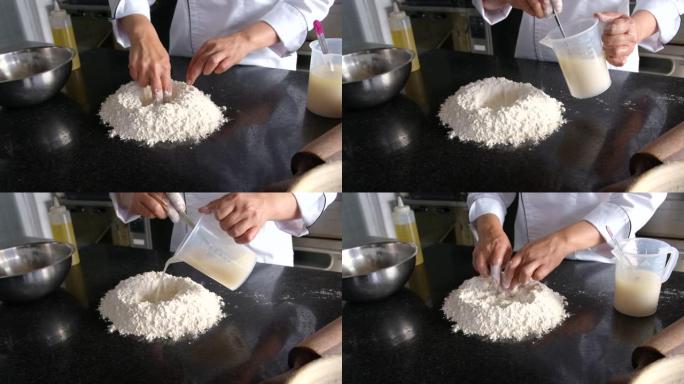 无法识别的女性面包师开始用面粉，酵母和水的混合物制作面团的过程