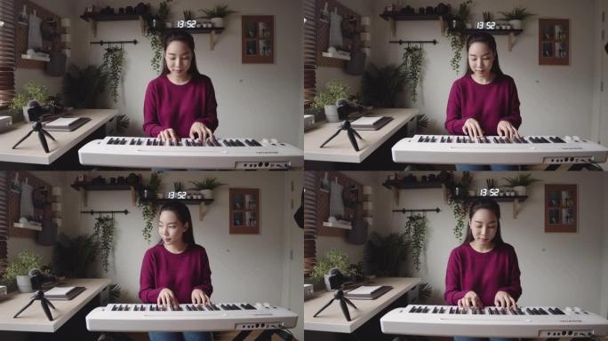 年轻女子在家通过视频教程在互联网上上钢琴课。