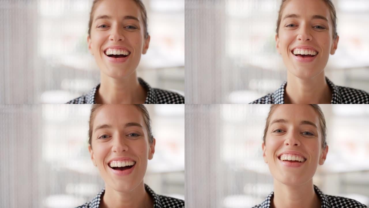 4k视频片段，一个快乐的年轻女商人在她的办公室