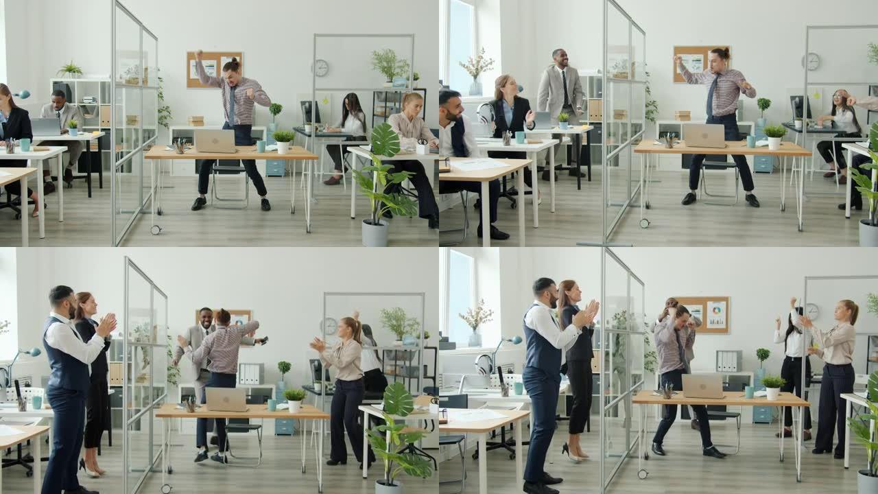 成功的上班族使用笔记本电脑然后跳舞，而商人则为享受成功而鼓掌