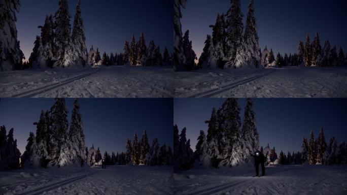 SLO MO越野滑雪运动员晚上用头灯滑雪