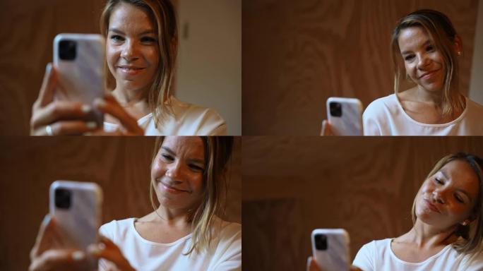 幸福女人用手机摄像头自拍