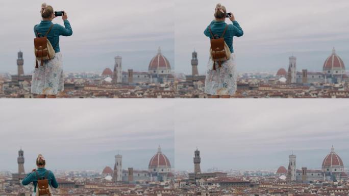 SLO MO无法识别的女人使用智能手机从米开朗基罗广场拍摄佛罗伦萨的照片