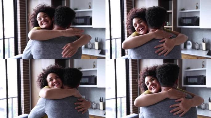 深情的幸福女人在伴侣到家后兴奋地拥抱着她的伴侣