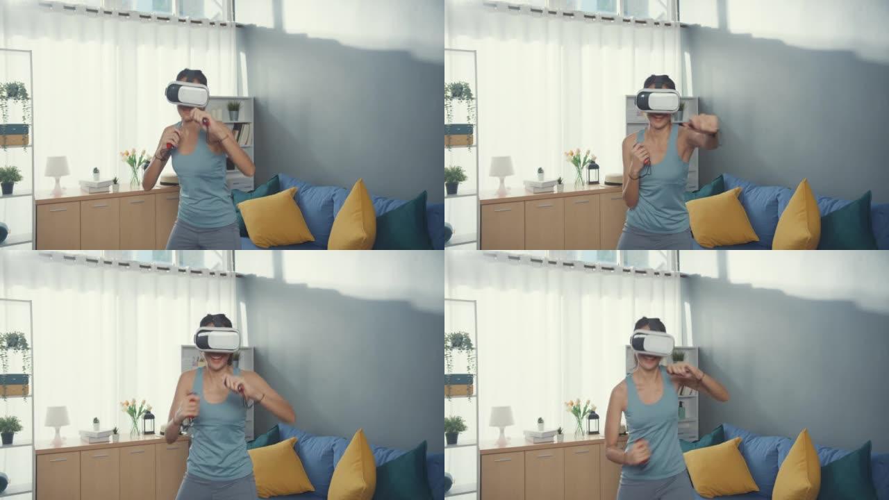 穿着虚拟现实耳机的年轻迷人的亚洲女性穿着运动服在家里的客厅玩开关游戏拳击练习在线节目。家庭检疫锻炼和