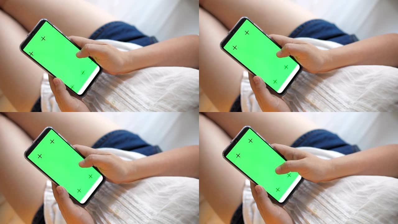 女人手触摸手机，卧室绿屏