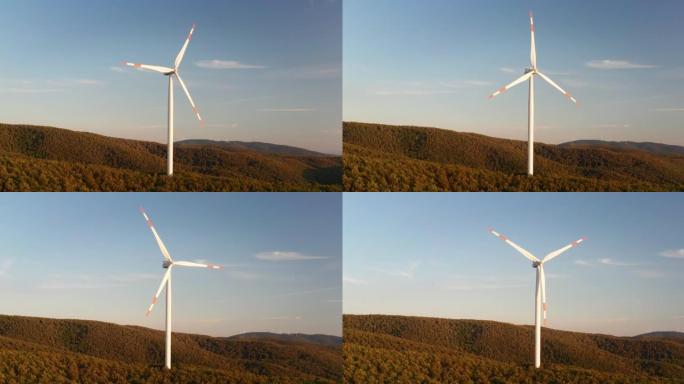 在日落时，风车在风力作用下旋转并以绿色生态方式向地球产生可再生能源的空中特写镜头。