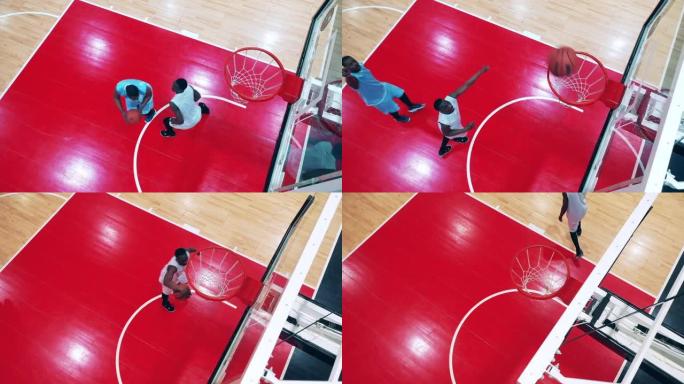 两名非裔美国球员在健身房进行篮球练习的俯视图