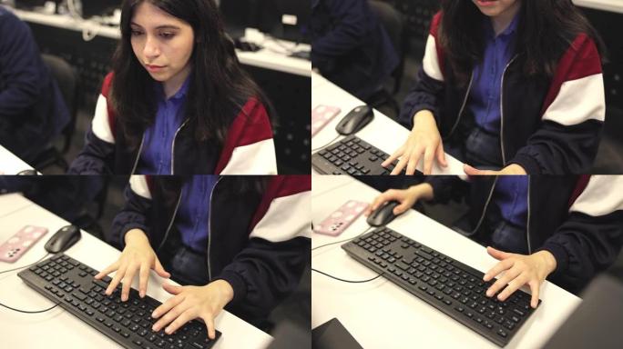 在大学计算机实验室工作的青少年学生