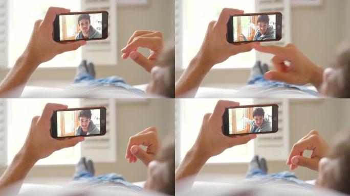 一个无法识别的男子使用智能手机进行视频通话的4k视频片段