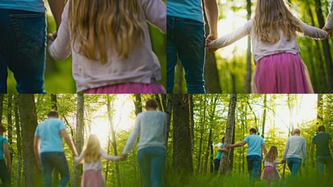 SLO MO父母在走过绿色森林时牵着女儿的手