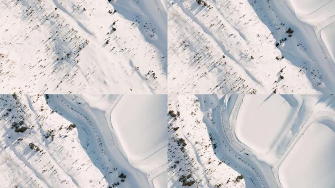 冬季仙境俯视图，无人驾驶飞机飞过白色冬季滑雪胜地小屋村的建筑物，所有建筑物都被深雪覆盖。