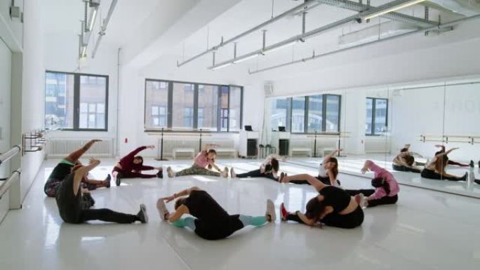 在舞蹈工作室一起进行热身运动的多种族人群