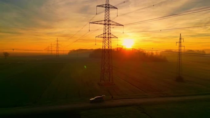 日落时乡村的电塔和电线