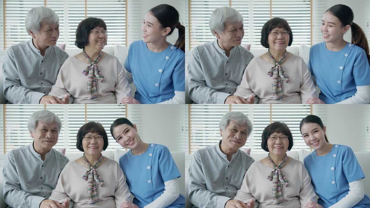 快乐的亚洲老年夫妇的肖像合影，在家庭护理中坐在沙发沙发上微笑，看着相机，享受退休或检疫时光。亚洲成人