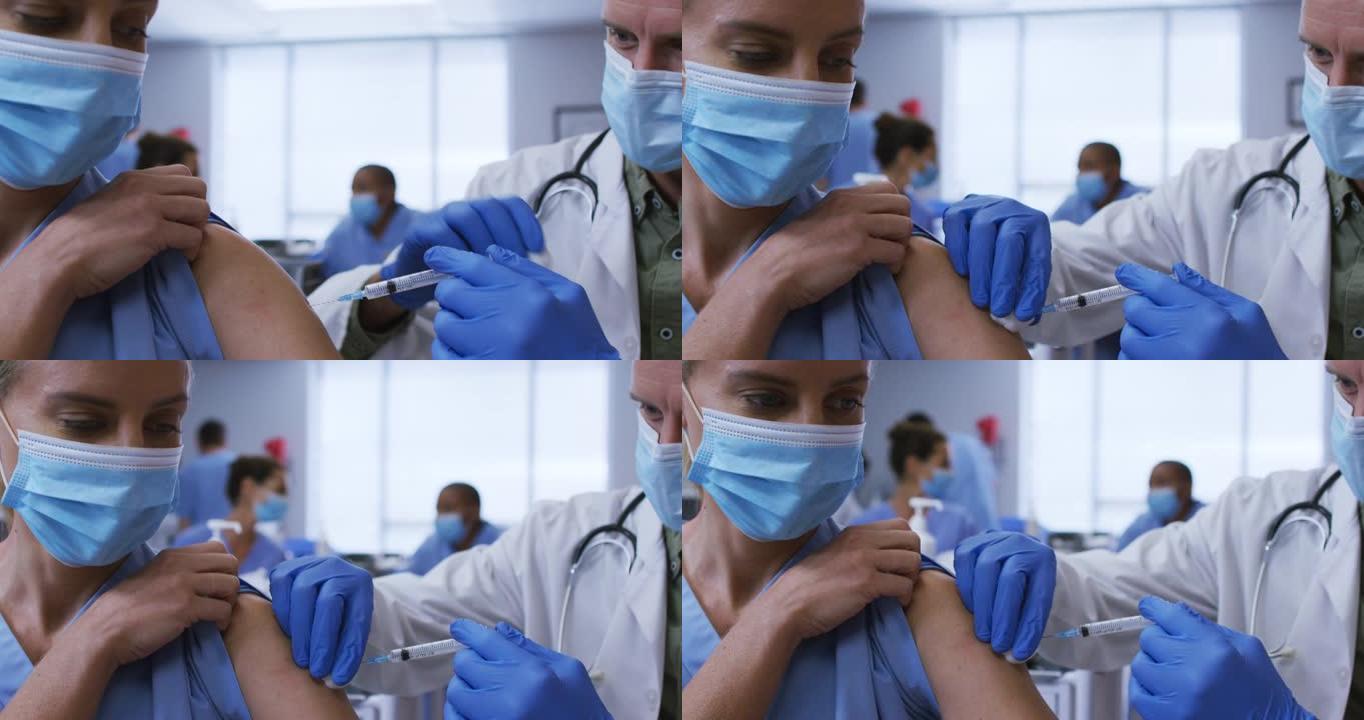 高加索男医生在医院给女同事接种covid疫苗，都戴着口罩