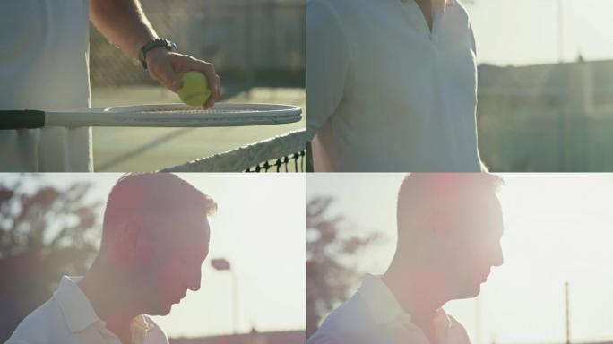 成熟的男人从网球拍上捡起球