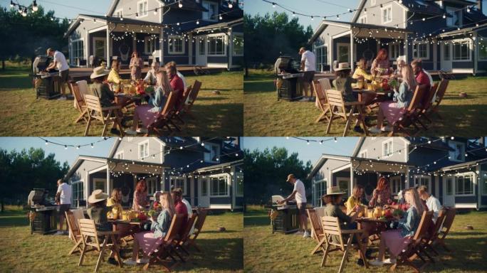 一群多民族的人在户外用餐时玩得开心，互相交流。在温暖的夏日，家人和朋友聚集在家外。