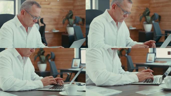 一名商人在办公室使用笔记本电脑的4k录像