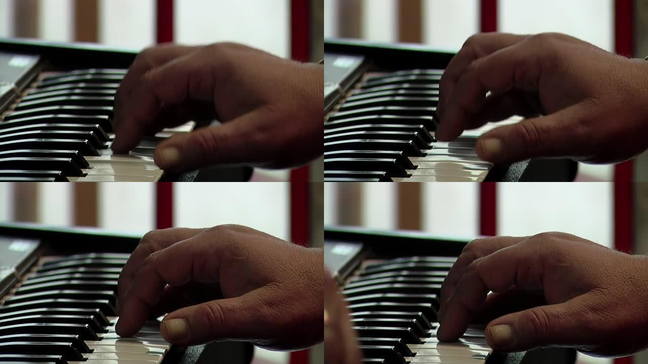 一个玩电钢琴的人的手。特写。