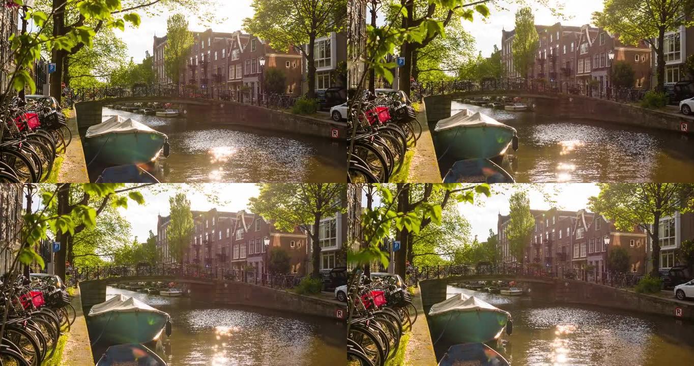 荷兰阿姆斯特丹带自行车和船只的运河上的田园诗般的桥梁