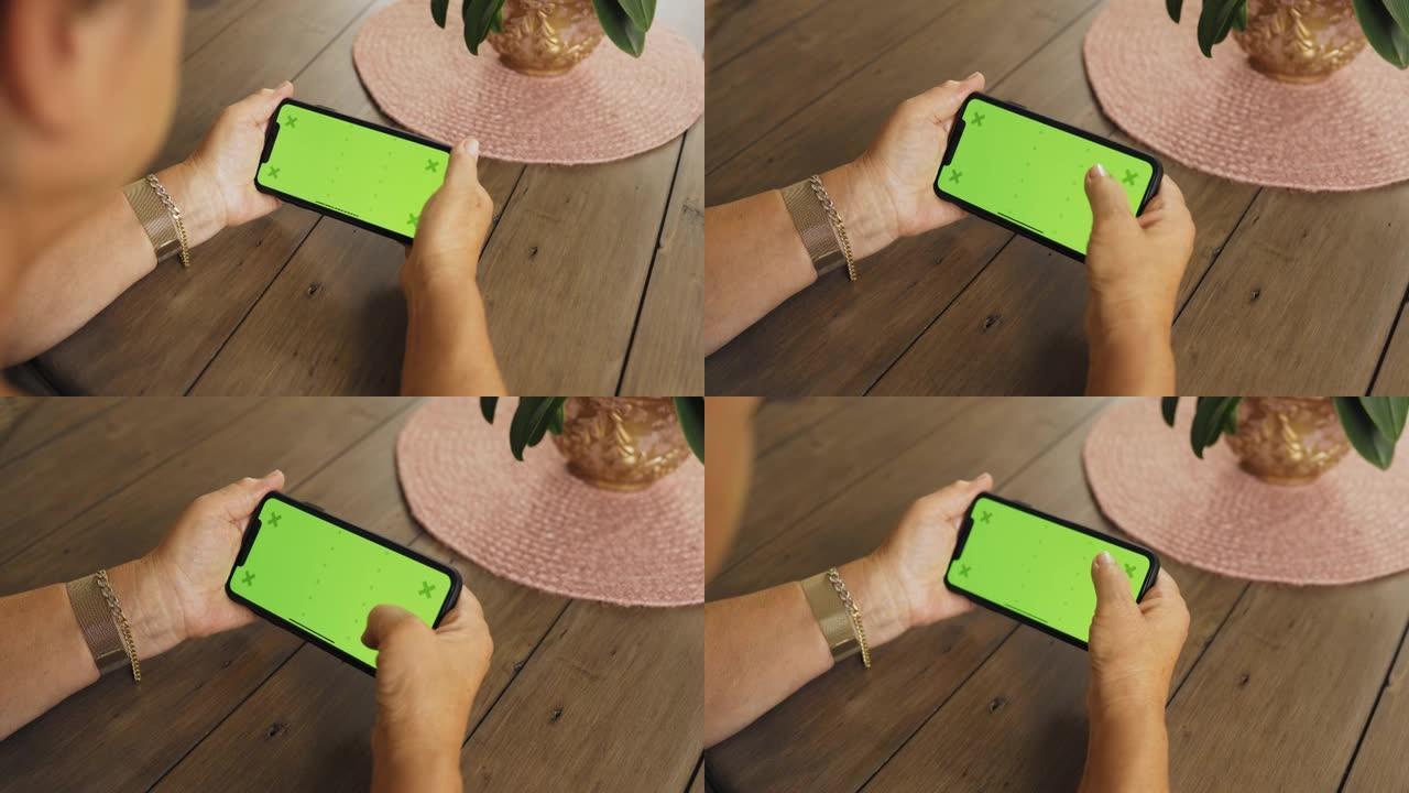 女人使用绿屏智能手机