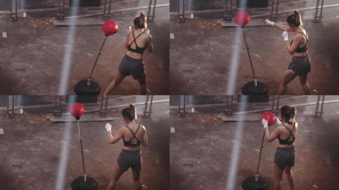 亚洲运动女运动员运动训练训练拳击在废弃的黑暗健身房