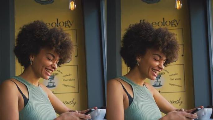 女性顾客在咖啡店橱窗中使用手机短信的垂直视频