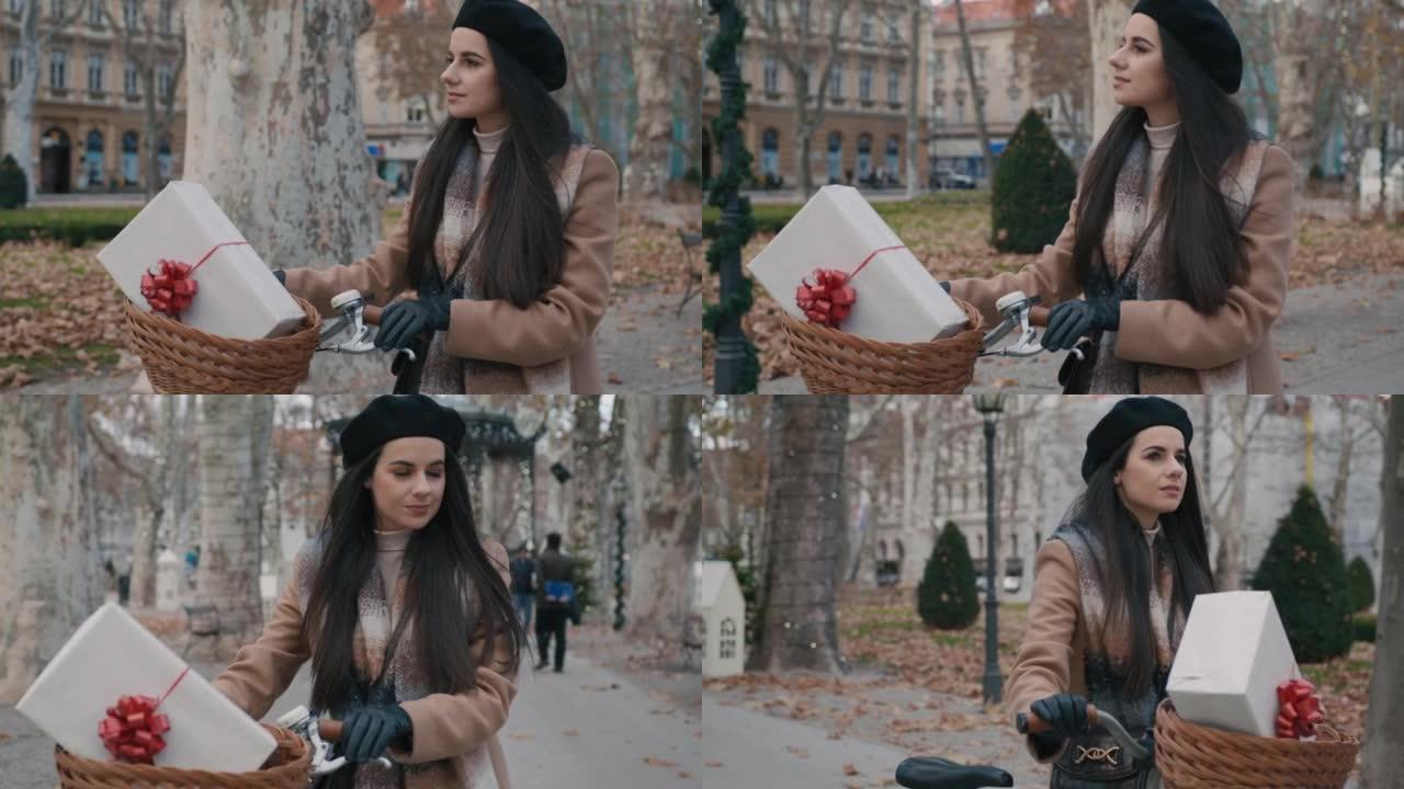 年轻女子骑着自行车带着圣诞礼物散步
